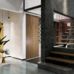 Modern interior with floating wooden staircase, black stone wall, and indoor plants designed by dimensionstudionline