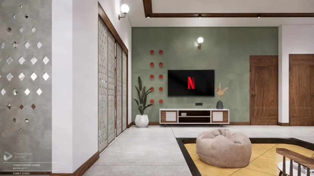 Modern family living room with a wall-mounted TV, green accent wall, cozy beige beanbag, wooden doors, and decorative wall panel